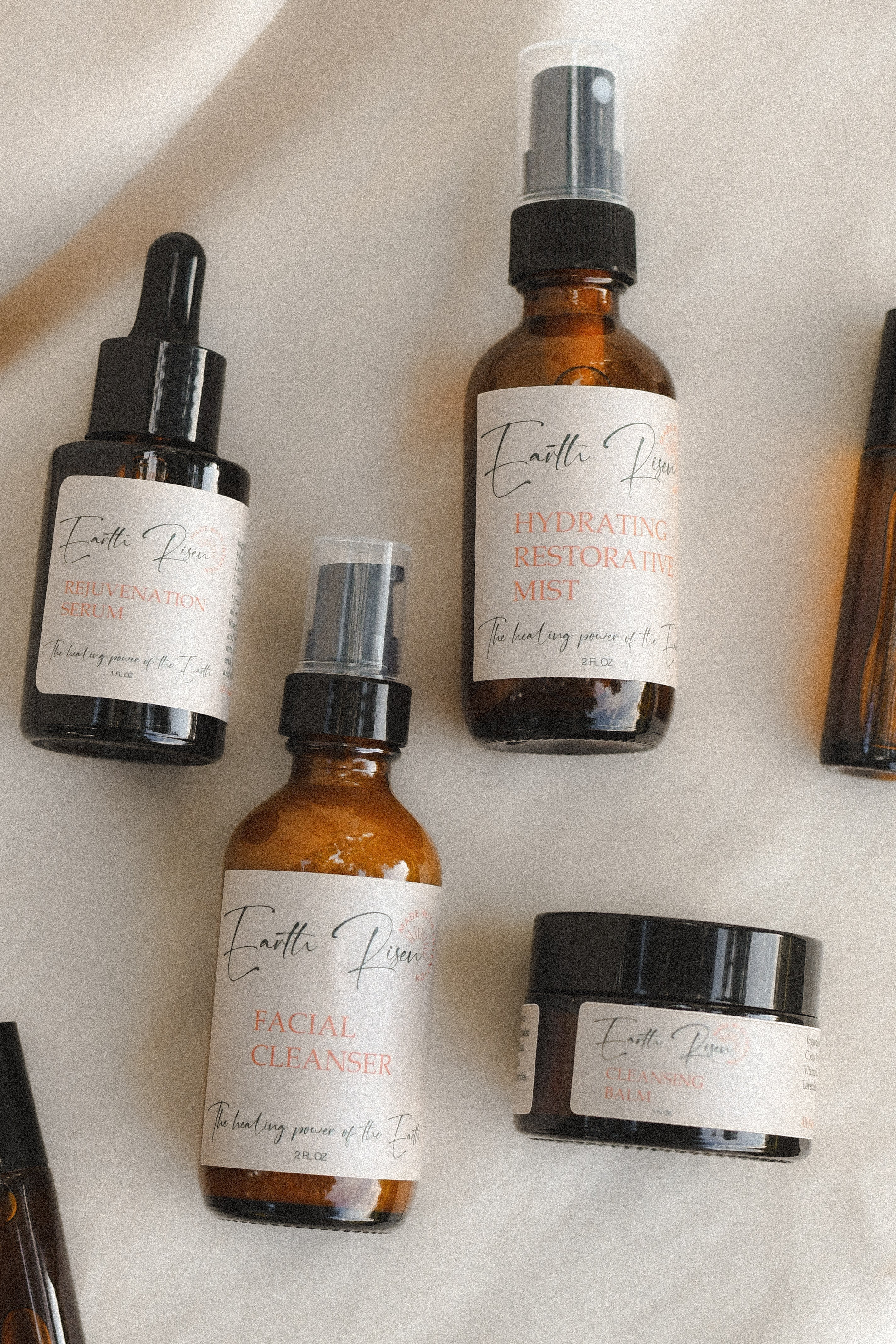 Earth Risen skincare products laid out on a table
